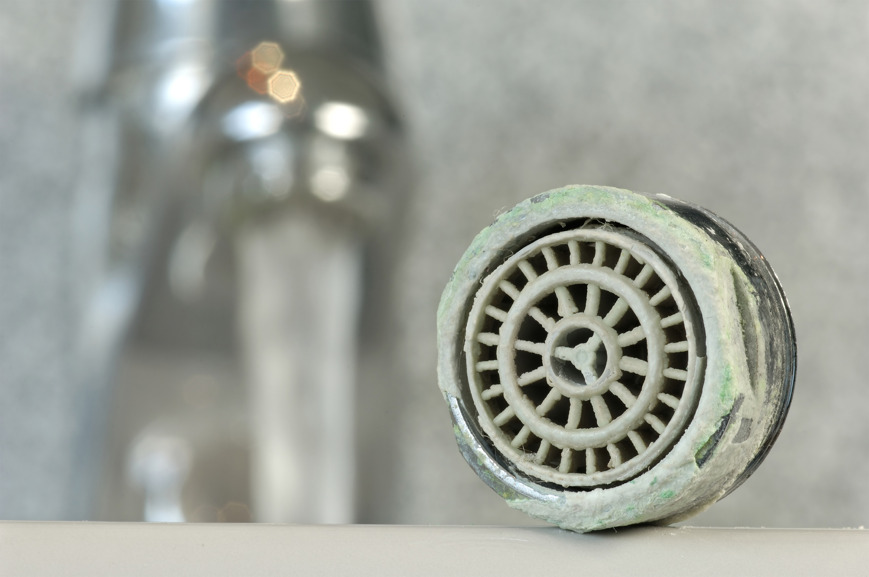 A shower head built up with hard water corrosion