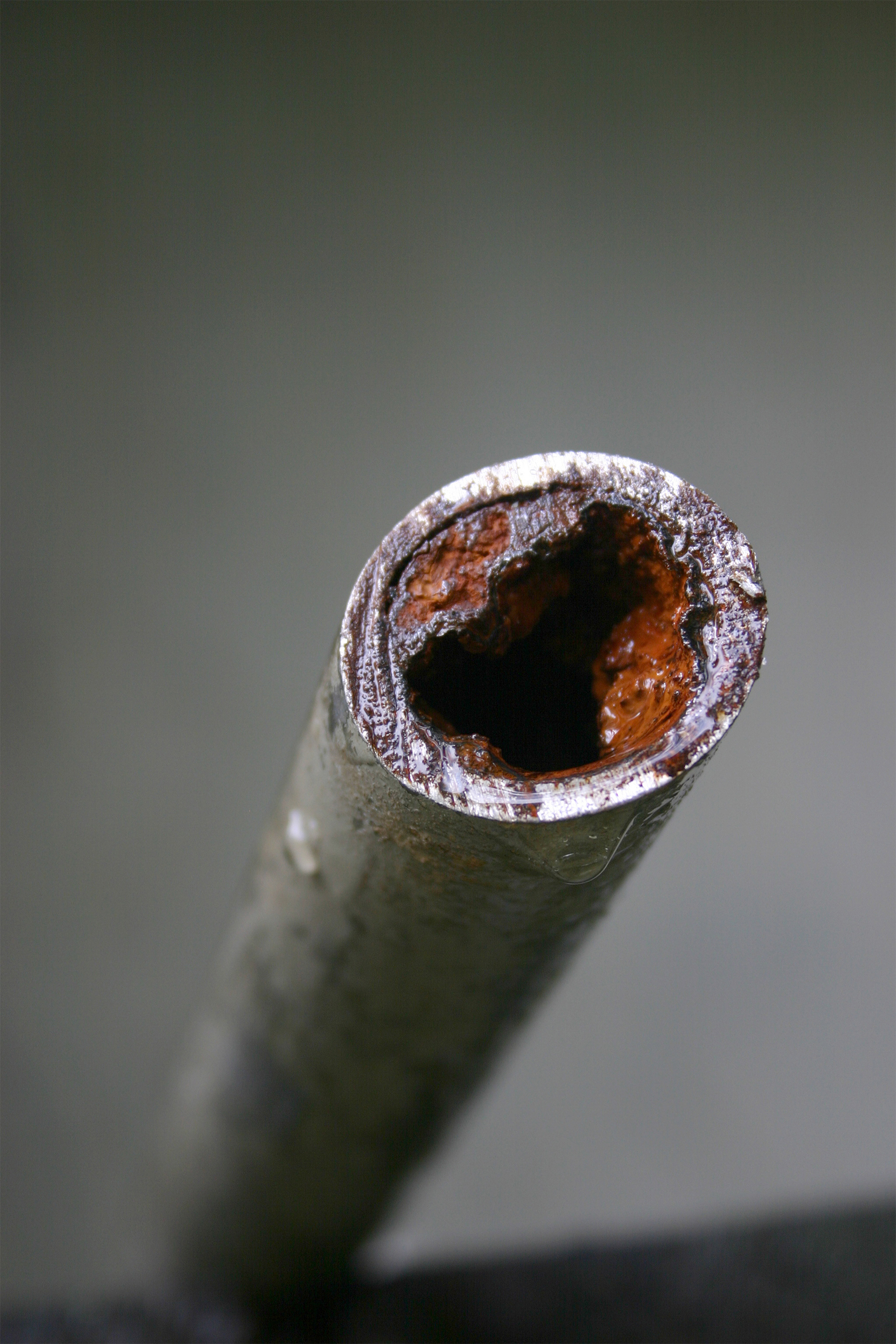 A household water pipe that has experienced hard water corrosion